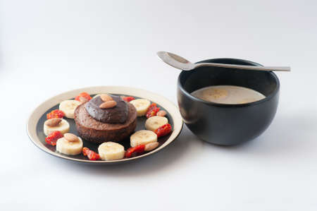 Handmade breakfast chocolate souffle and fruits soup on white backgroundの写真素材