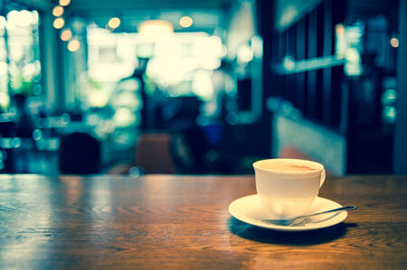 Coffee cup in coffee shop - vintage effect filterの写真素材