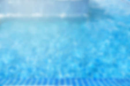 Blur blue clear water in swimming pool