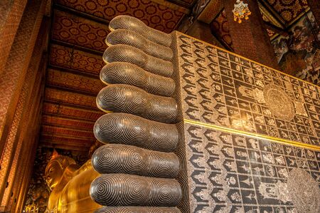 Reclining Buddha gold statue face. Wat Pho, Bangkok, Thailandの写真素材
