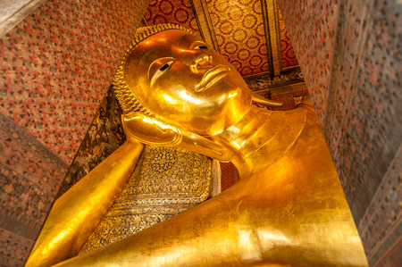 Reclining Buddha gold statue face. Wat Pho, Bangkok, Thailandの写真素材