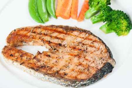 Grilled Salmon Steak with Boiled Vegetables Isolated on a White Backgroundの写真素材