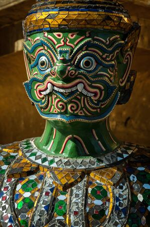 The Demon Statue Supporting Golden Pagoda on Grand Palace, Temple of the Emerald Buddha Wat Phra Kaew, Bangkok, Thailand.の写真素材