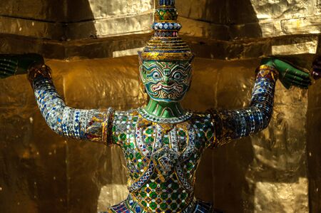 The Demon Statue Supporting Golden Pagoda on Grand Palace, Temple of the Emerald Buddha Wat Phra Kaew, Bangkok, Thailand.の写真素材