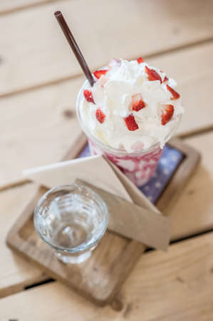 Strawberry smoothie on the table with blank card - soft focus pointの写真素材