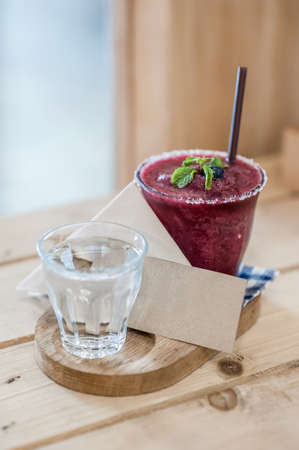 Blueberry smoothie on the table and blank card - soft focus pointの写真素材