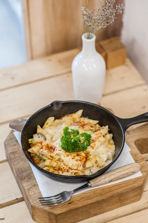 Cheesy baked macaroni and cheese pasta portion with parmesan sprinkled on top - soft focus pointの写真素材