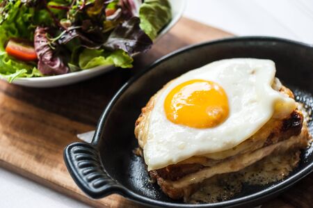 Breakfast menu with beautiful fried eggs, bread and hamの写真素材
