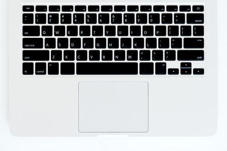 A laptop keyboard on a white wooden table. Top viewの写真素材
