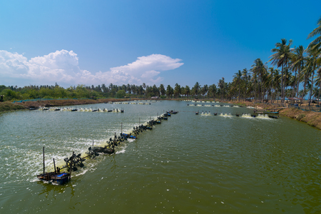 Aerator turbine wheel oxygen fill ins Into lake water. Shrimp farm, Thailandの写真素材