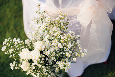 Chair decorated with flowers in wedding ceremonyの写真素材