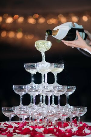 Pyramid of glasses of champagne in wedding ceremonyの写真素材
