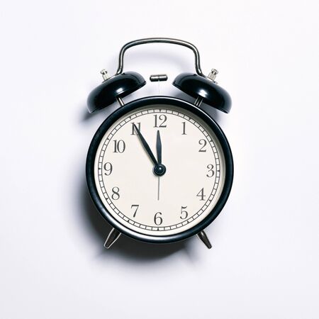 black alarm clock on white background. close up shot. top view.の写真素材