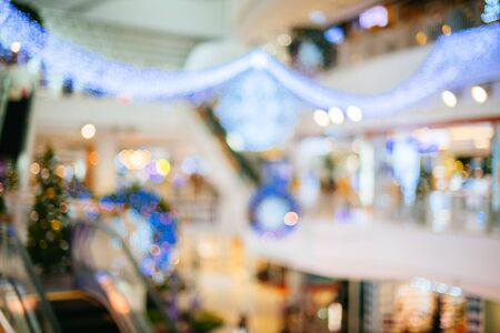 Blur christmas holidays banner, tree, bokeh background. Blur background in the shopping mall.の写真素材