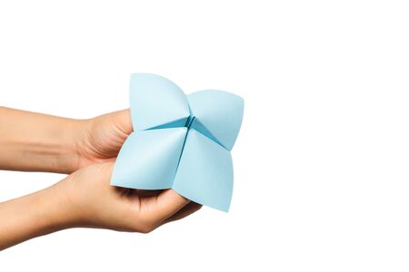 Close up of hand in a paper fortune teller isolated on white background.の写真素材