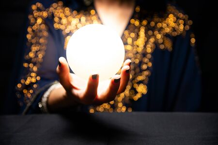 Fortune teller's hands with crystal ballの写真素材