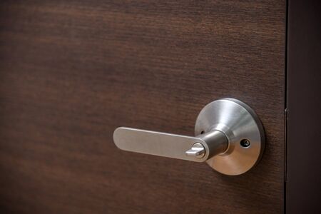 Stainless door knob and wooden doorの写真素材