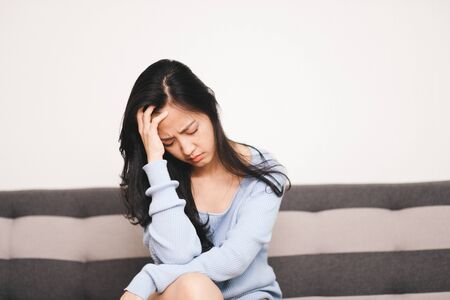 Panic attacks young girl sad fear stressful depressed emotional on the sofa. A person with anxiety, people with bad feeling down healthy.の写真素材