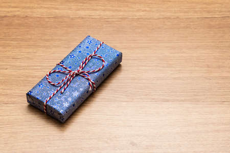 gift box with red ribbon on wooden backgroundの写真素材