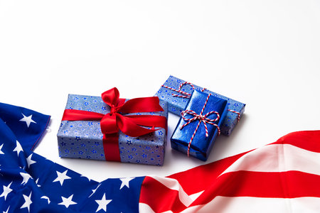 4th of July American Happy Independence Day card with gift boxes in national colors american flag on white background, Flat lay, top view, copy space, banner.の写真素材