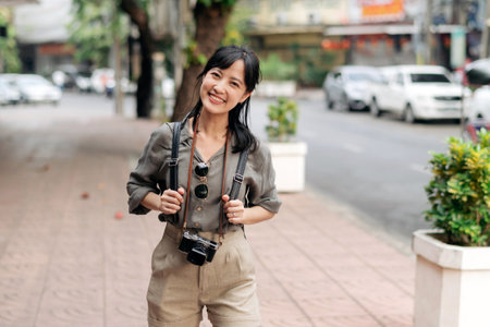 Young Asian woman backpack traveler enjoying street cultural local place and smile. Traveler checking out side streets.の写真素材