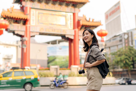 Young Asian woman backpack traveler enjoying China town in Bangkok, Thailand. Journey trip lifestyle, world travel explorer or Asia summer tourism concept.の写真素材