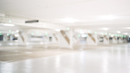 Blurred image of empty car park in basement of shopping mall. Defocused background conceptの写真素材