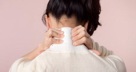Young asian woman hold her hand on pain neck and injury ache shoulder stress problem muscle. Office syndrome disease, healthcare conceptの写真素材