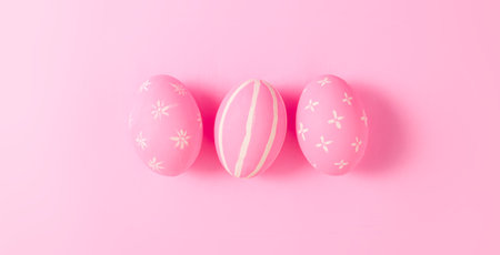 Happy Easter holiday greeting card concept. Pink Easter Eggs pastel pink background. Top view, flat lay, copy space.の写真素材