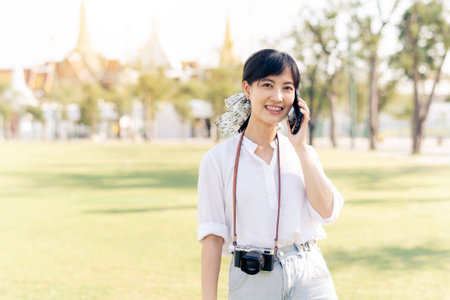 Portrait beautiful young asian woman with smartphone on summer holiday vacation trip in Thailandの写真素材