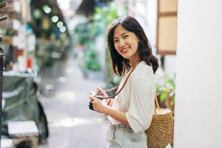 Asian woman traveler using camera. Asia summer tourism conceptの写真素材