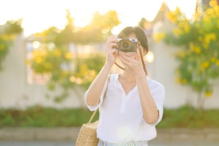 Asian woman traveler using camera. Asia summer tourism concept