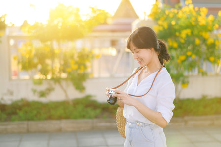 Asian woman traveler using camera. Asia summer tourism conceptの写真素材
