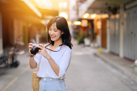 Asian woman traveler using camera. Asia summer tourism conceptの写真素材