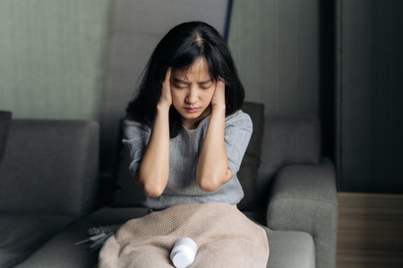 Asian woman has a headache. Female holding painful head. People with head problem, Healthcare And Medicine.の写真素材