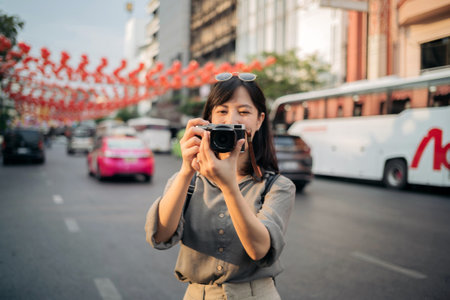 Young Asian woman backpack traveler enjoying China town in Bangkok, Thailand. Journey trip lifestyle, world travel explorer or Asia summer tourism concept.の写真素材