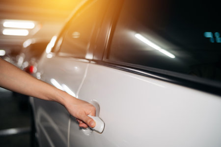 Business woman hand open person white car. Driver, service, lock, automotive insurance concept. Automobile vehicle female owner catching a door handle.の写真素材