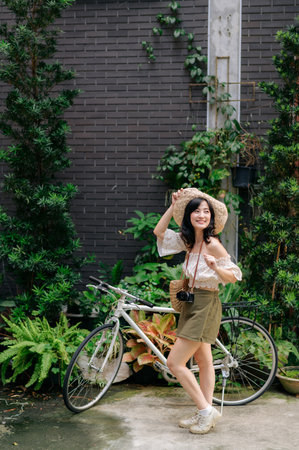 Happy asian youth woman with camera travels street city trip on leisure weekend. Young hipster female tourist sightseeing summer urban Bangkok destination. Asia summer tourism concept.の写真素材