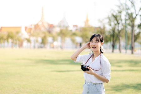 Asian woman traveler using camera. Asia summer tourism conceptの写真素材