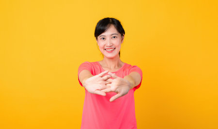 Portrait young beautiful asian sports fitness woman happy smile wearing pink sportswear posing exercise training workout isolated on yellow studio background. wellbeing and healthy lifestyle concept.の写真素材