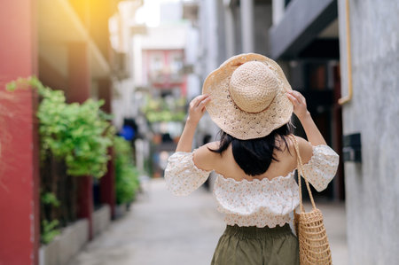 Happy asian youth woman with camera travels street city trip on leisure weekend. Young hipster female tourist sightseeing summer urban Bangkok destination. Asia summer tourism concept.の写真素材