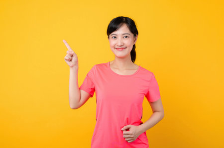 Portrait young beautiful asian sports fitness woman happy smile wearing pink sportswear posing exercise training workout isolated on yellow studio background. wellbeing and healthy lifestyle concept.の写真素材