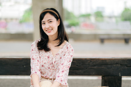 asian young woman traveler with weaving basket waiting for train in train station. Journey trip lifestyle, world travel explorer or Asia summer tourism concept.の写真素材