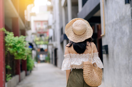 Happy asian youth woman with camera travels street city trip on leisure weekend. Young hipster female tourist sightseeing summer urban Bangkok destination. Asia summer tourism concept.の写真素材