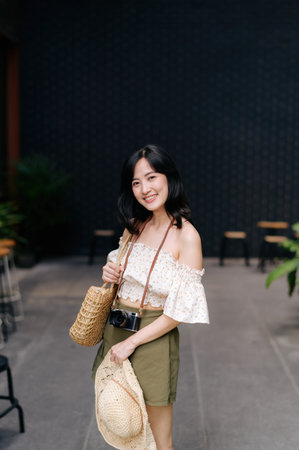 Happy asian youth woman with camera travels street city trip on leisure weekend. Young hipster...