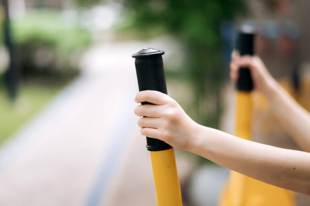 Close up of sportswoman hands while working out exercise equipment outdoor in park. Healthy lifestyle conceptの写真素材