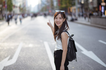 Vibrant and carefree, Asian woman's urban stroll captures the modern essence of confidence, style,...