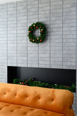 A Cozy living room with festive wreath on modern stone wall