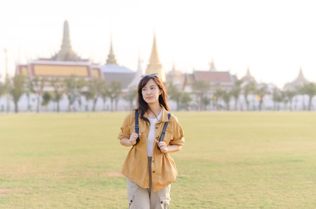 Traveler asian woman 30s exploring Wat Pra Kaew. From stunning architecture to friendly locals, she...