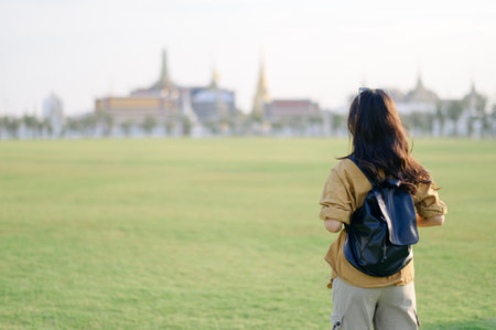 Traveler asian woman in 30s explores its grandeur. Discover the religious beauty and history of Bangkok with her journey.の写真素材